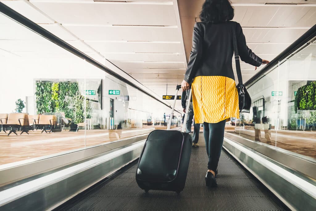 a woman pulling a suitcase